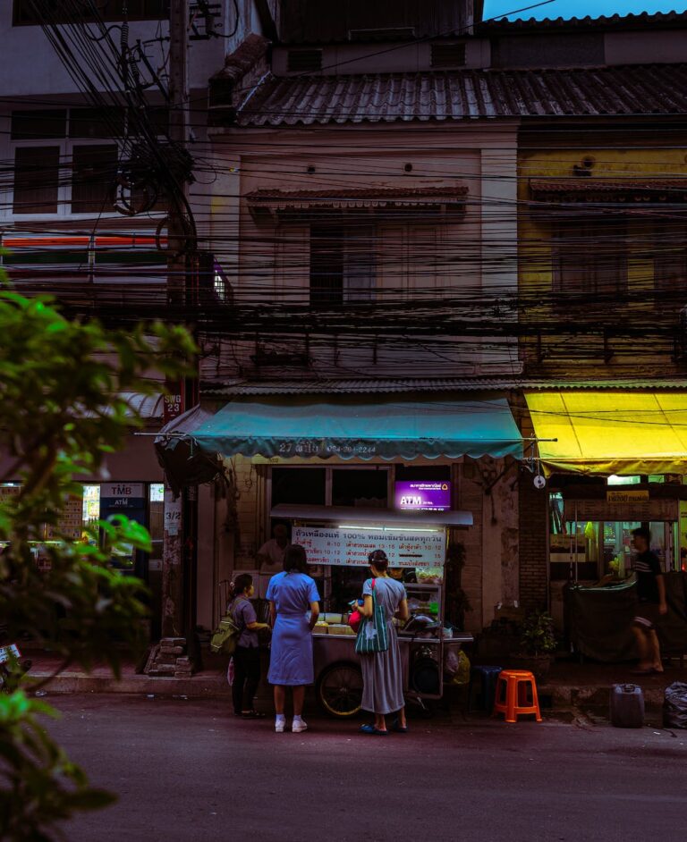 people standing in front of food stall