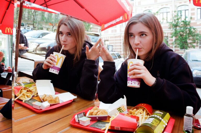 photo of a woman eating on mcdonald s