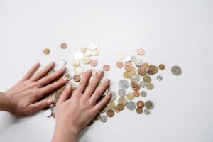 person holding silver round coins