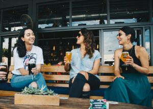 three women sitting on bench